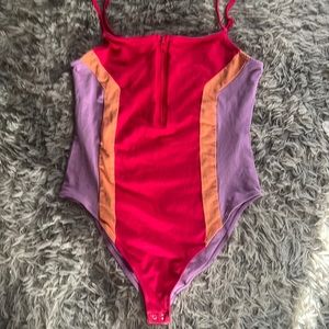 Super cute bodysuit. Never wore but tag is missing. Bright. Fun